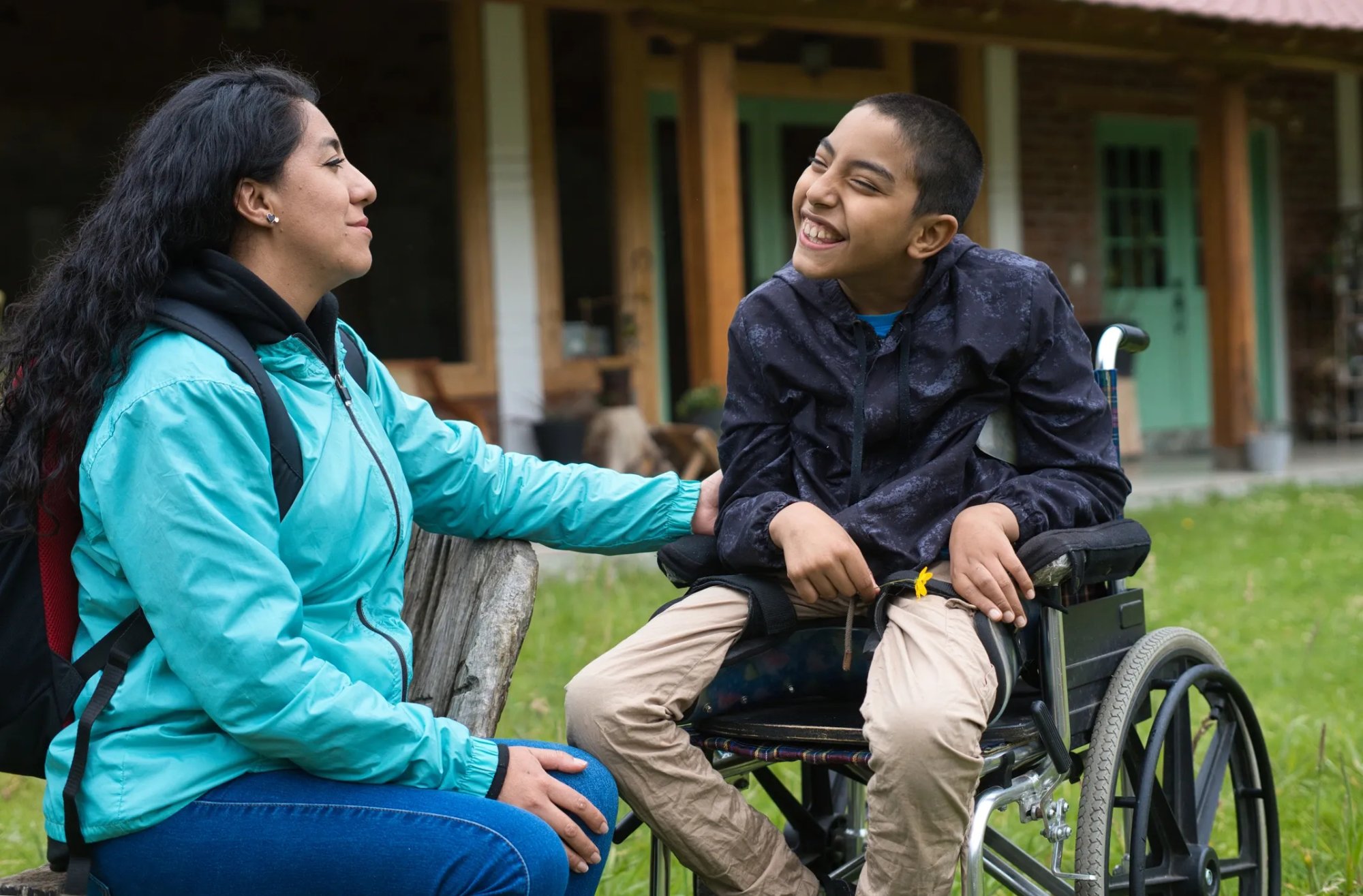 Carer with smiling child in wheelchair