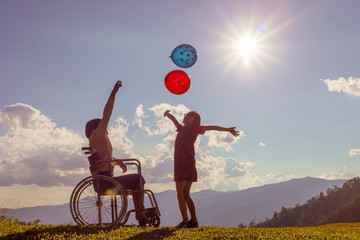Child in wheelchair playing in sunlight